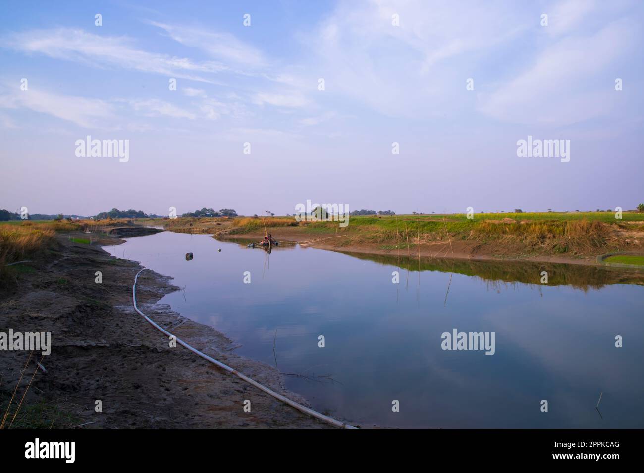 Arial View Canal with green grass and vegetation reflected in the water nearby Padma river in Bangladesh Stock Photo