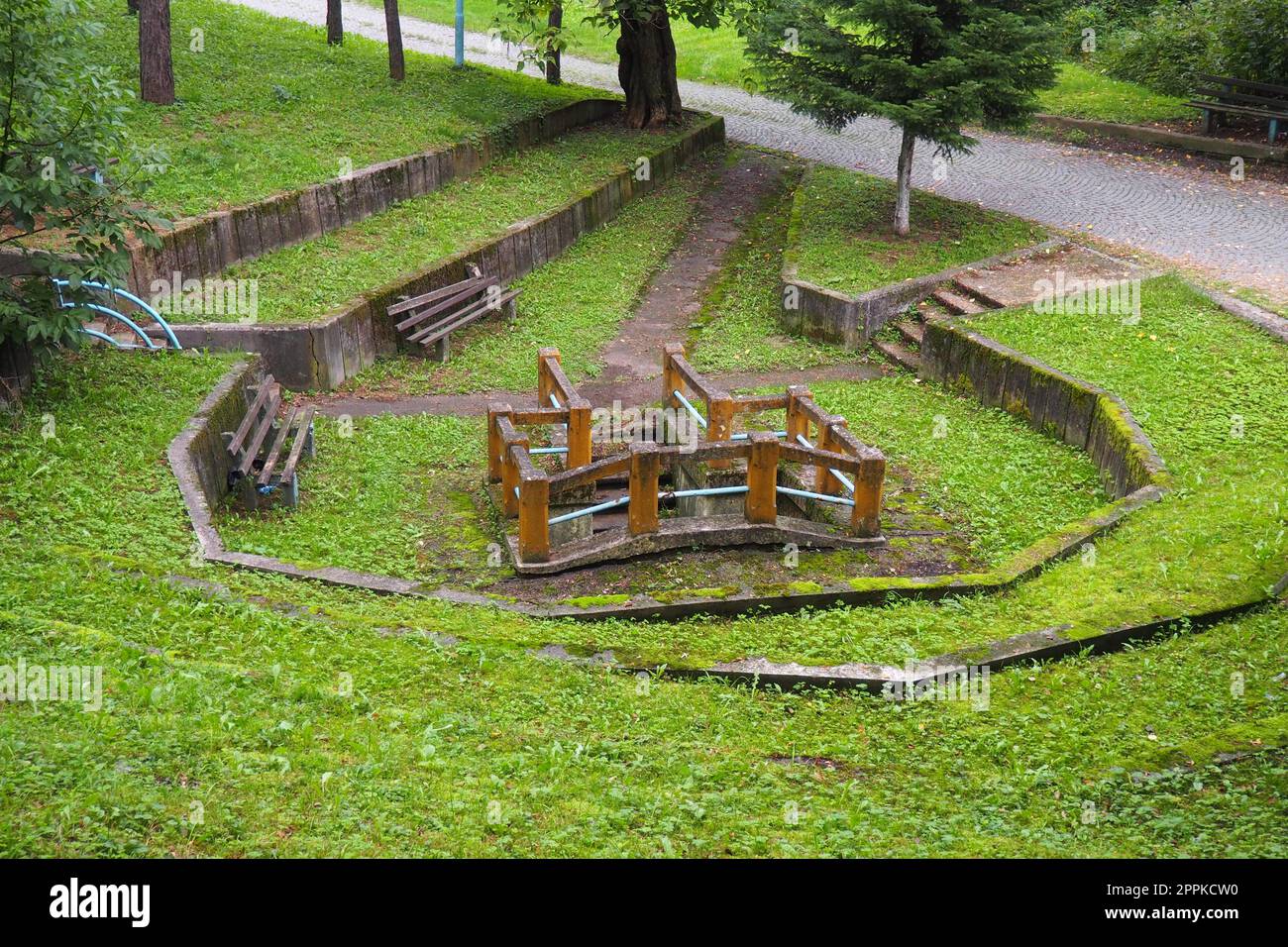 Banja Koviljaca, Loznica, Serbia. Mount Guchevo, park and forest. Source of mineral sulfuric and ferruginous water Rakina Chesma Cesma. A spring near the road to Guchevo. Concrete fence and stairs. Stock Photo