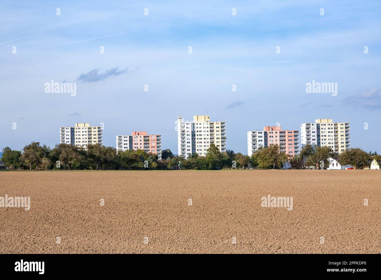 view to social housing projects with plowed field in foreground in Steinbach near Frankfurt Stock Photo