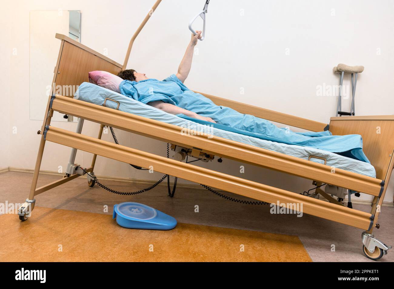sloped hospital bed with patient holding handle Stock Photo Alamy