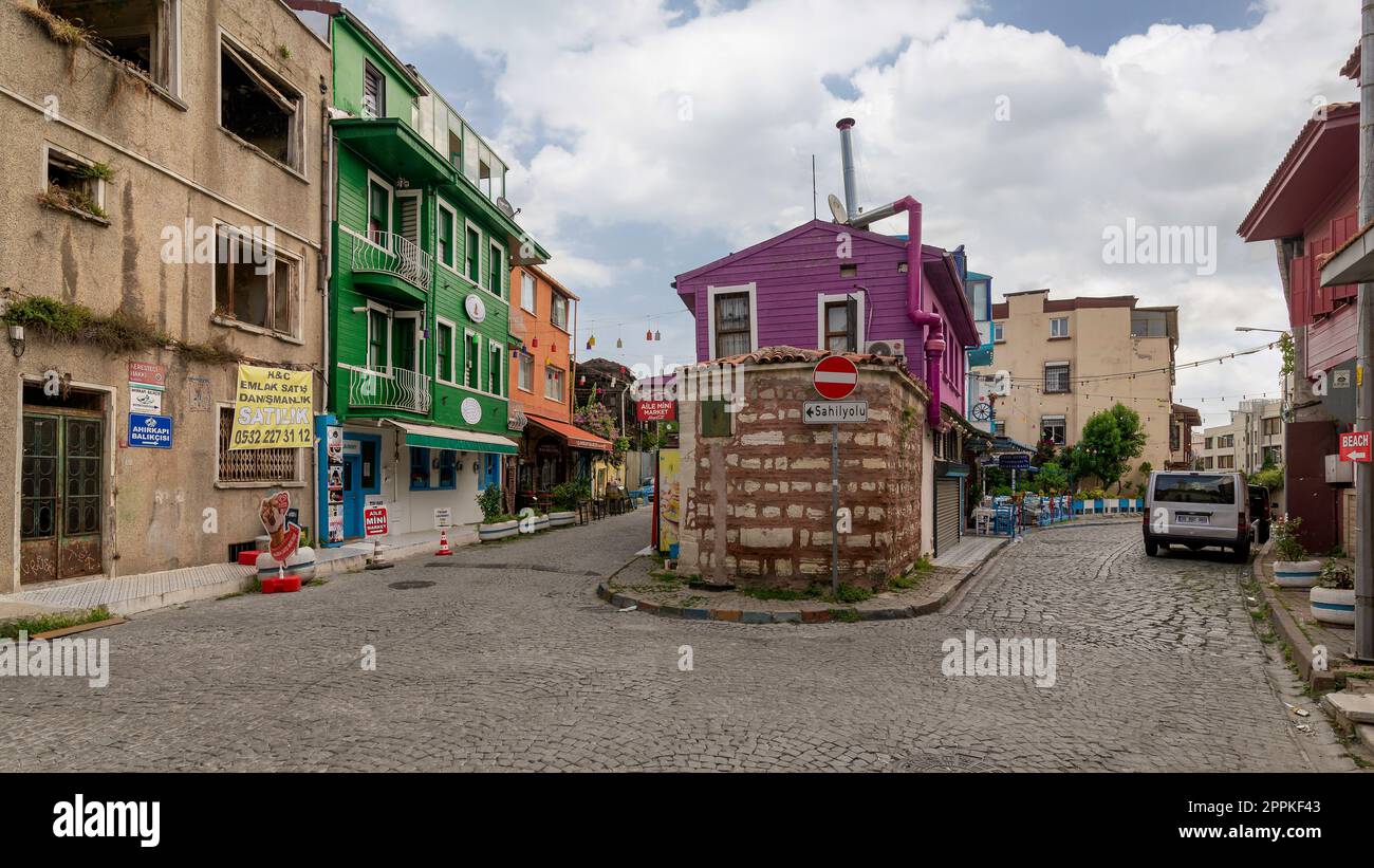 Cobblestone alley, with beautiful old houses painted in green, orange and pink, suited in Fatih district, Istanbul Stock Photo