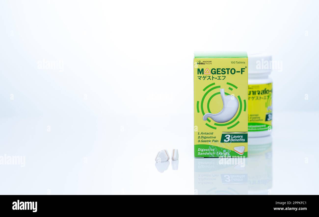 CHONBURI, THAILAND-SEPTEMBER 23, 2022: Magesto-F tablets pill with drug bottle and paper box packaging. Licensed by Takeda Pharmaceutical company. Digestive sandwich tablets. Healthcare product. Stock Photo