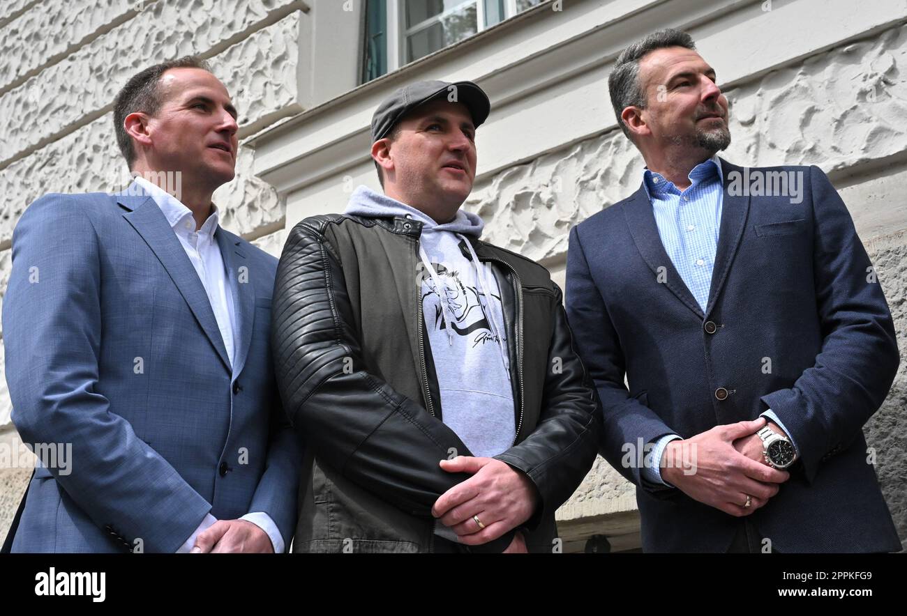 Munich, Germany. 24th Apr, 2023. Fabian Bayrhammer (l-r), Sebastian  Bayrhammer and Florian Bayrhammer, grandsons of actor Gustl Bayrhammer,  stand in front of the former workshop of Meister Eder from the TV series 
