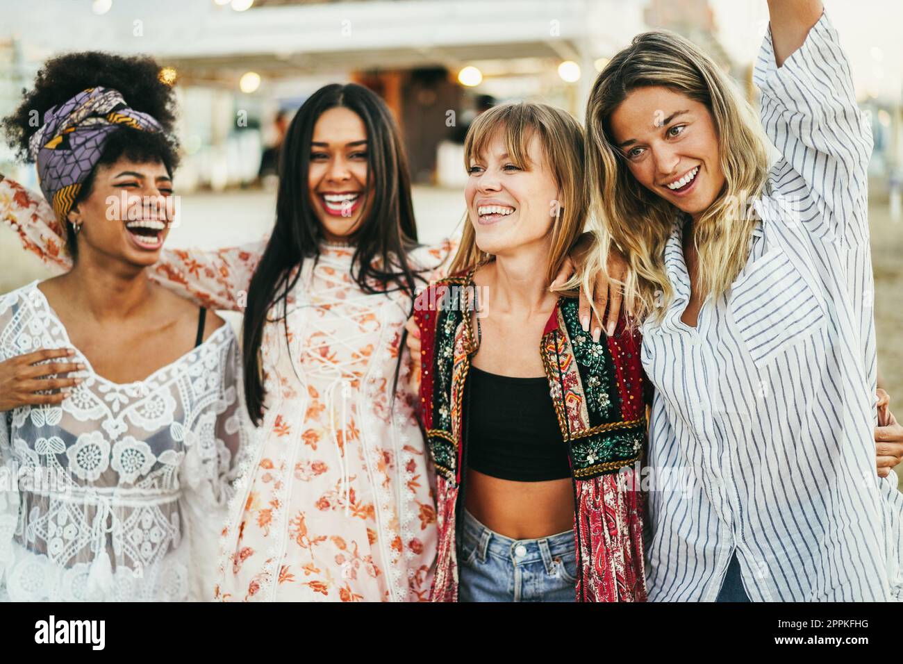 Multiracial happy friends having fun outdoor at beach party - Focus on girl wearing black shirt Stock Photo