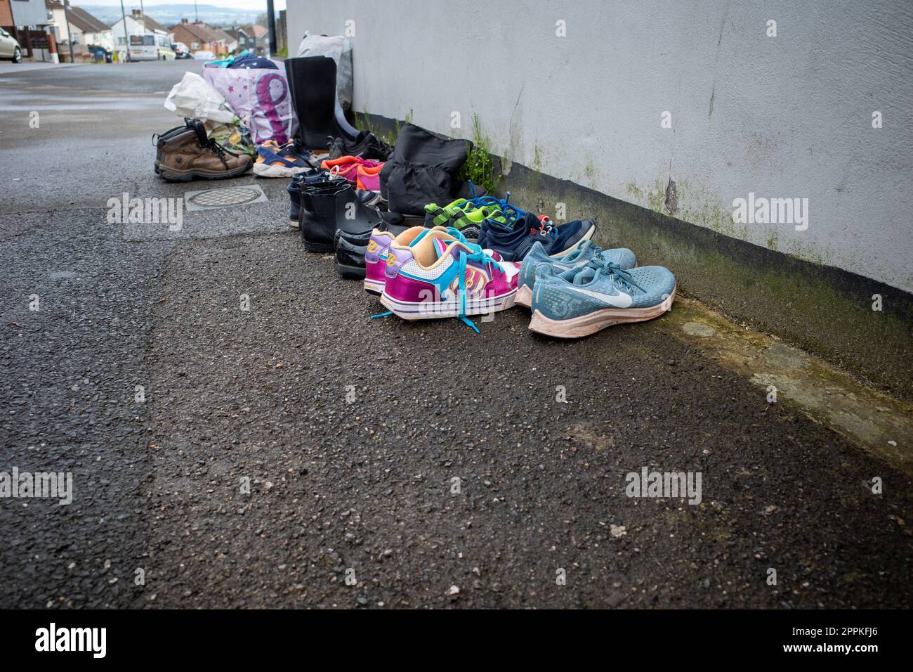 A select of trainers, shoes and boots left outside for recycling Stock Photo
