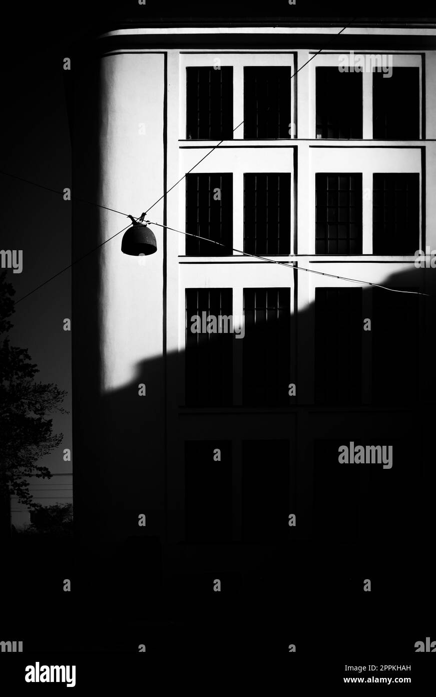 A Vintage Streetlight Against The Windows Of An Urban Building In 