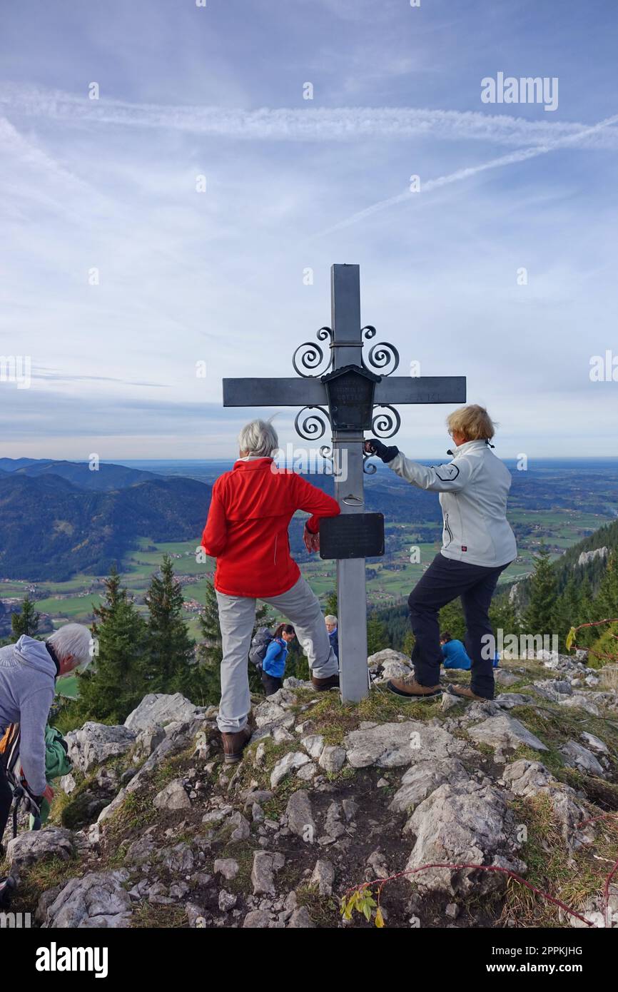 Europe, Germany, Upper Bavaria, Mangfall Mountains, Schweinsberg mountain, Wendelstein mountain, summit cross, hikers Stock Photo