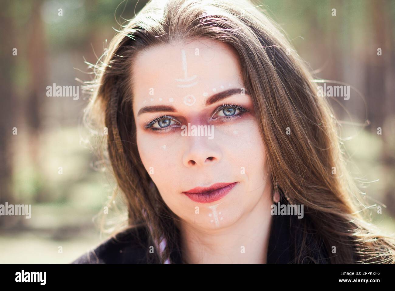 Close up woman with traditional shaman signs on face portrait picture Stock Photo