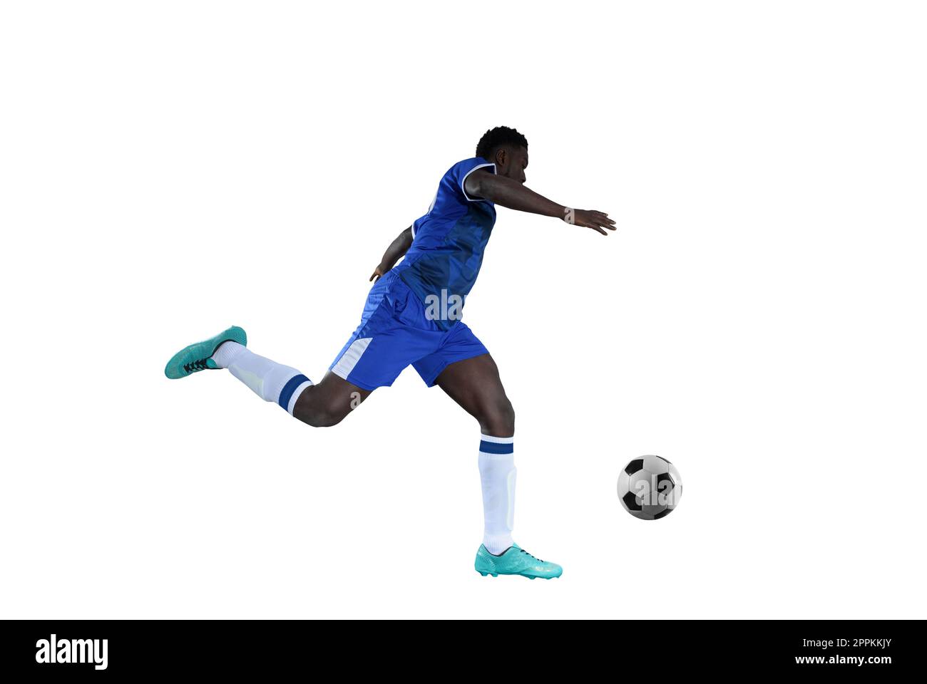 Football striker with blue team suit chases the soccerball Stock Photo