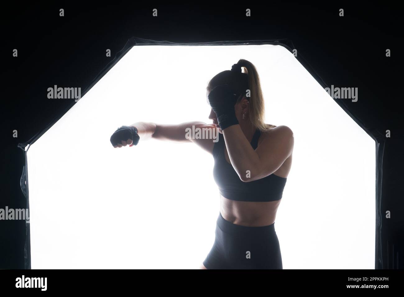 Woman do a high kick, taebo. Athletic fit female with perfect body kick air, punching with legs