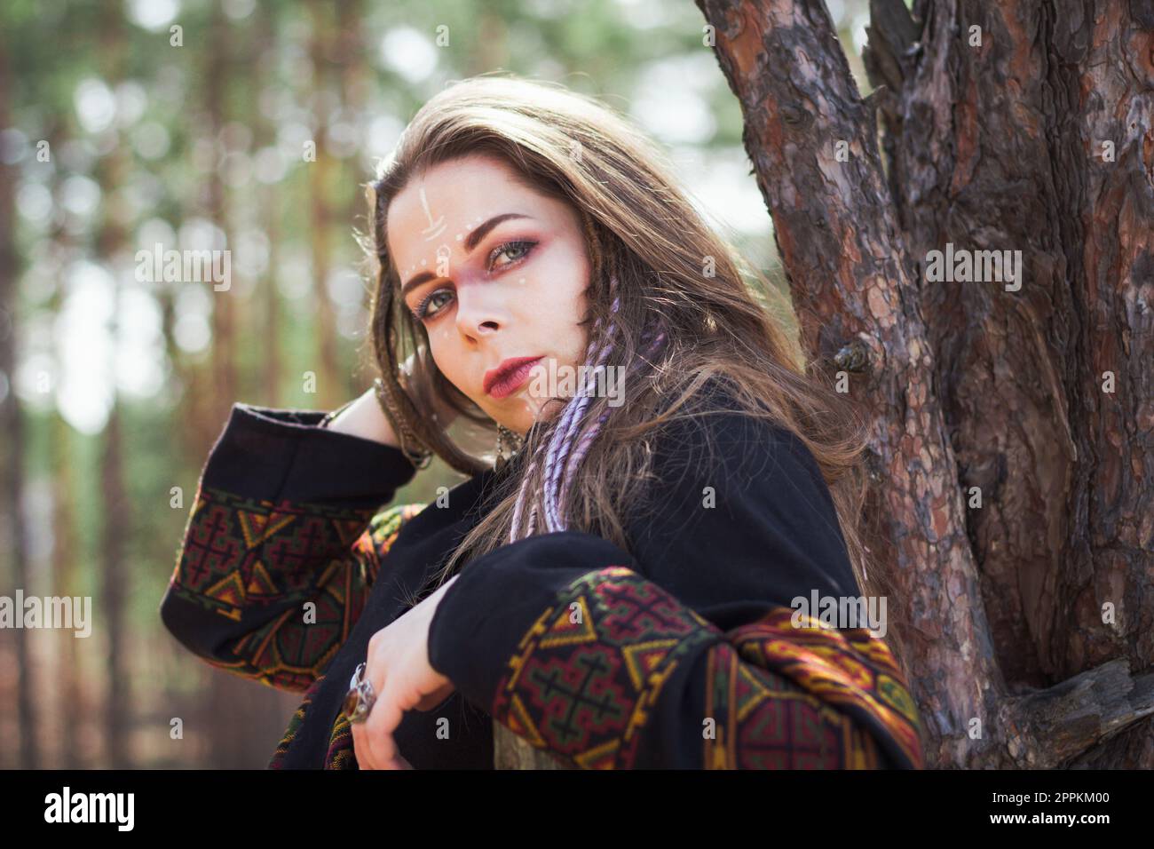 Close up mysterious lady with tribal patterns on face portrait picture Stock Photo