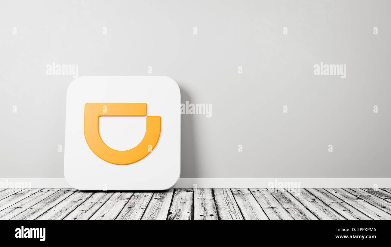 Didi App Icon on Wooden Floor Against Wall Stock Photo