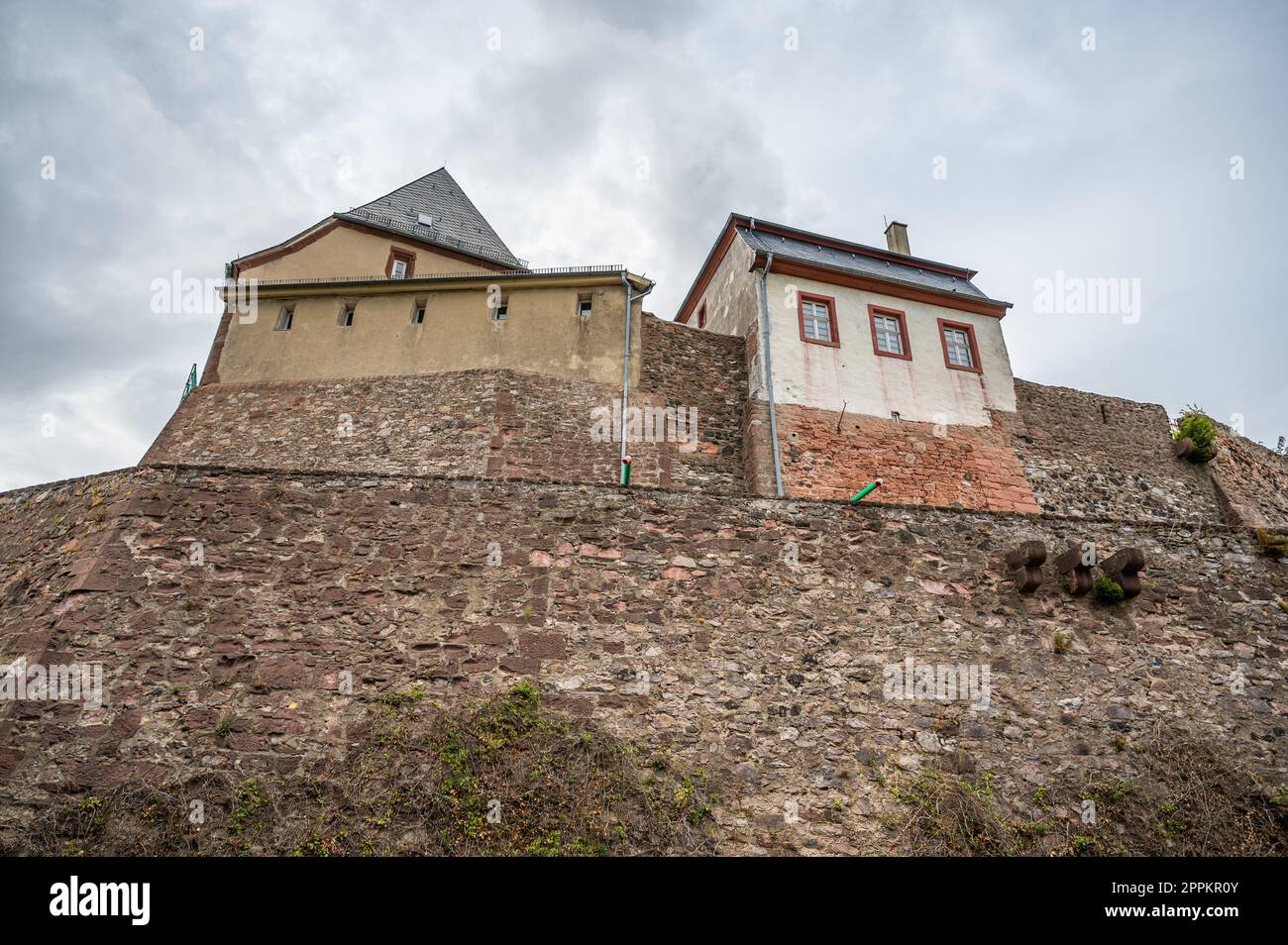 Castle Veste Otzberg, odenwald, view from low angle with old wall in front, cloudy day, germany Stock Photo