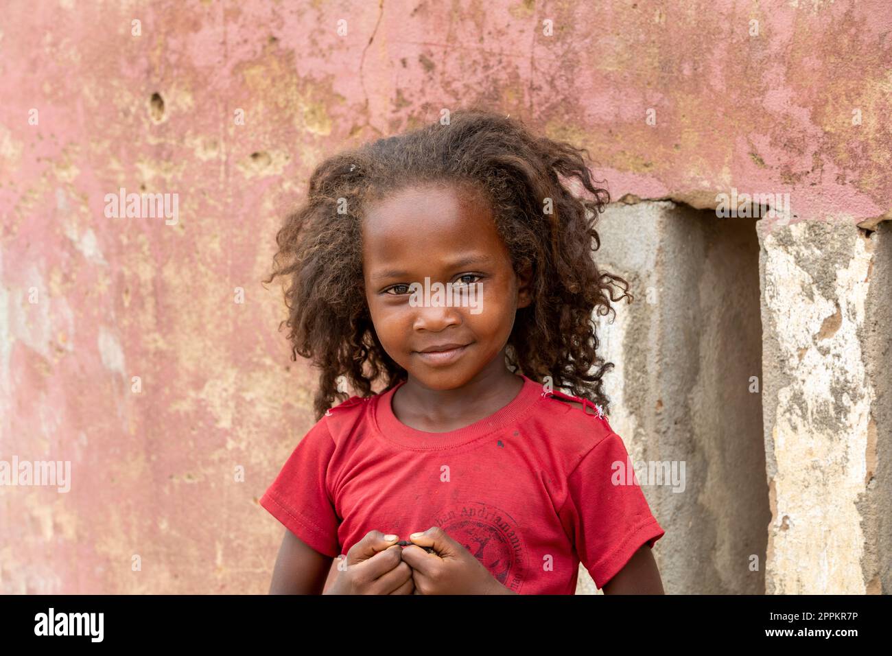 Small cute Malagasy girl with long hair , little dancer on celebration in village Bekopaka, region Melaky, Madagascar. Stock Photo