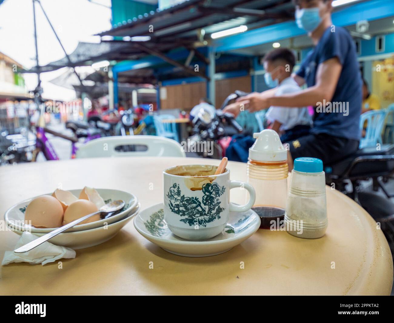 Breakfast on the idyllic Pulau Ketam, Malaysia. Pulau Ketam is near Port Klang and was built by Chinese fishermen centuries ago. Pulau means island and Ketam means crabs. This islands has millions of tiny crabs! The island is home to two predominantly Chi Stock Photo