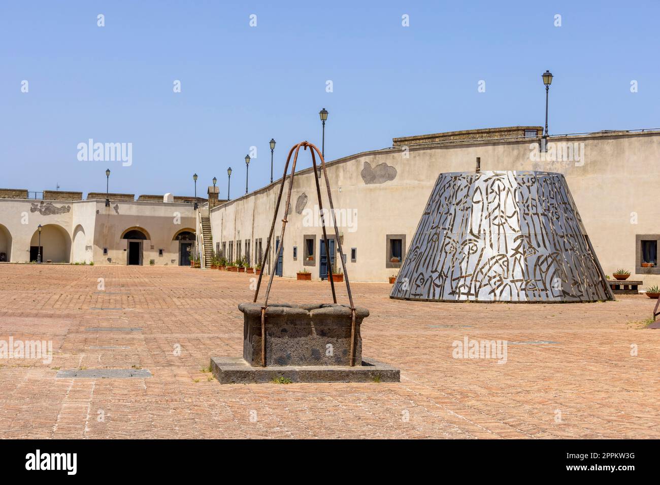 Medieval Castel Sant'Elmo with old well and modern art, metal sculpture, Naples  Italy Stock Photo