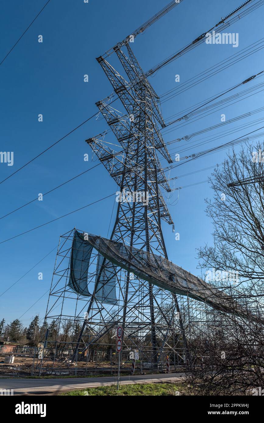 A newly installed high-voltage pylon with some cables connected Stock Photo