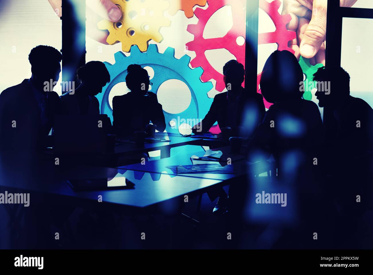 Business team connect pieces of gears. Teamwork, partnership and integration concept. double exposure with light effects Stock Photo