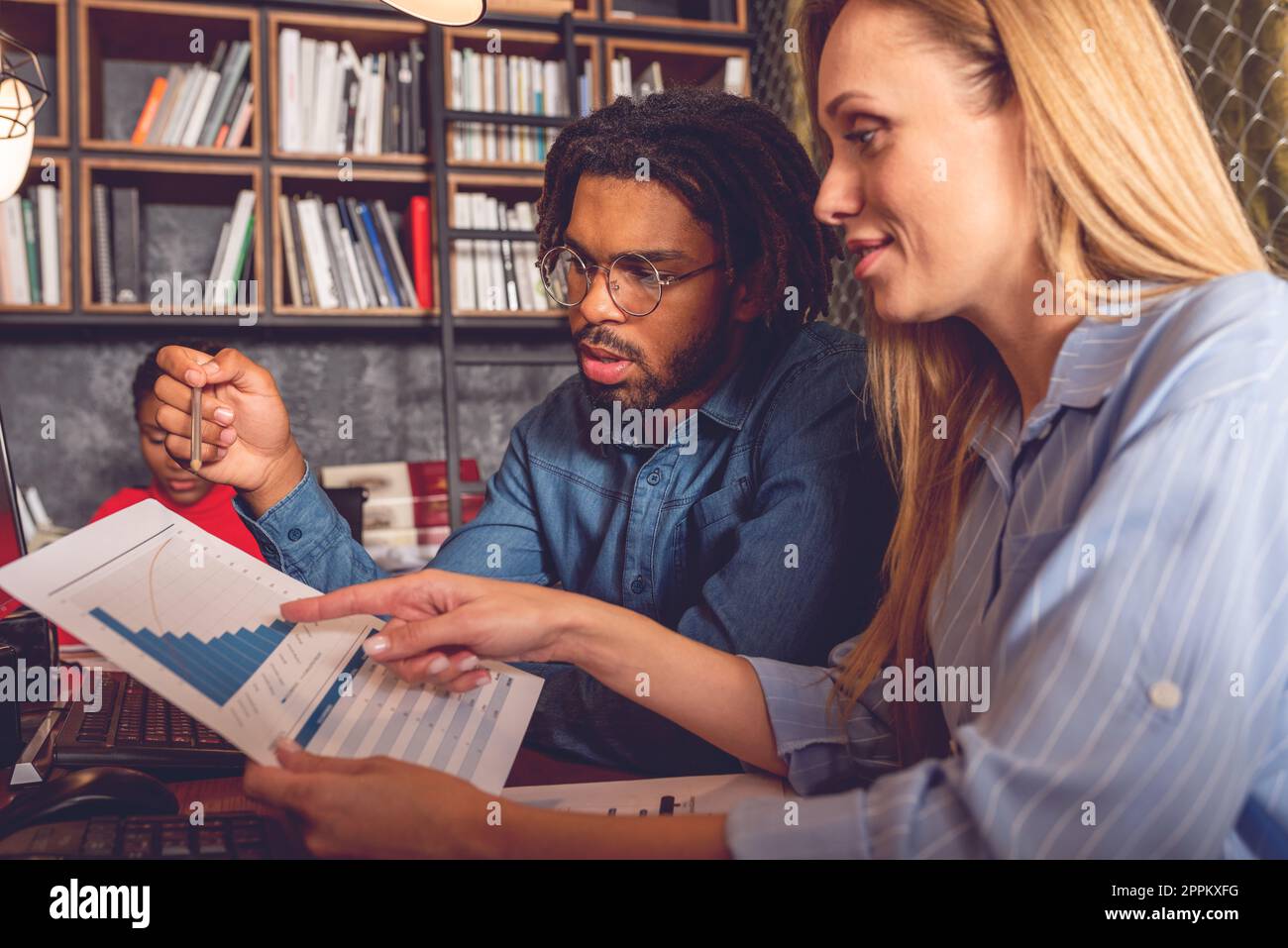 Young smiling business man and woman working together in the office ...