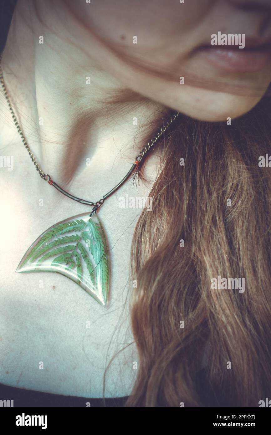 Close up woman with craft pendant concept photo Stock Photo