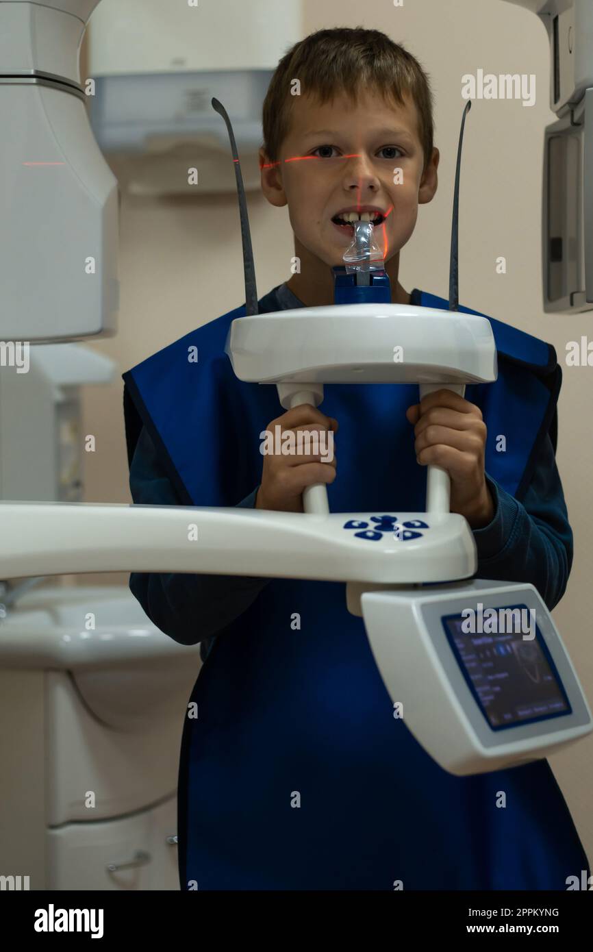 Jaw computed tomography, check up teeth in dental clinic. Boy with open mouth on x-ray diagnostics. Circular snapshot. Stock Photo