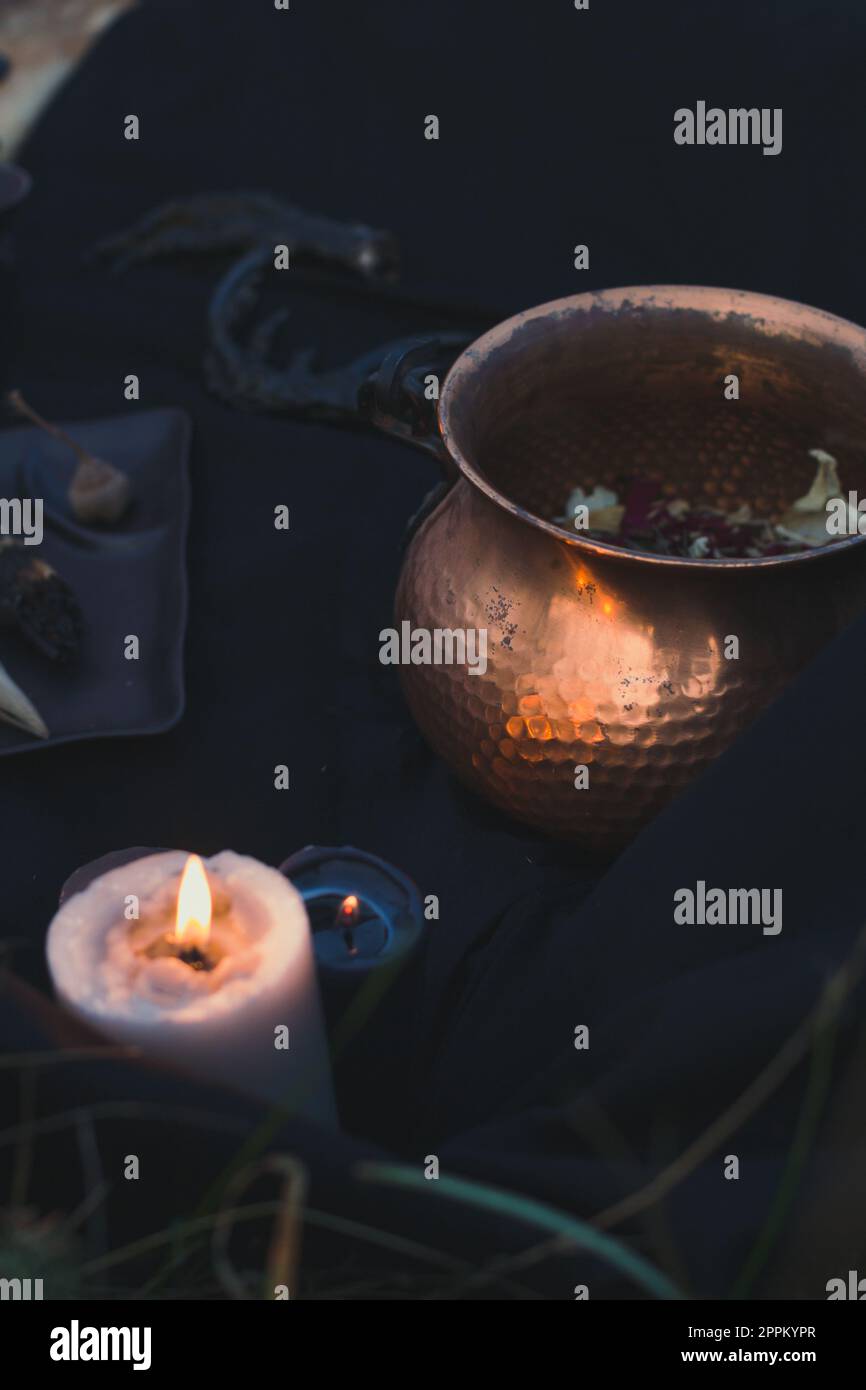 Close up witch cauldron and burning candle concept photo Stock Photo