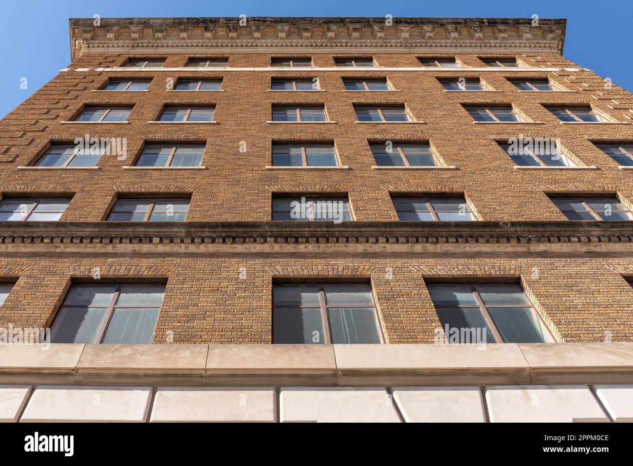 Looking up the brick facade of the the front of the San Angelo National