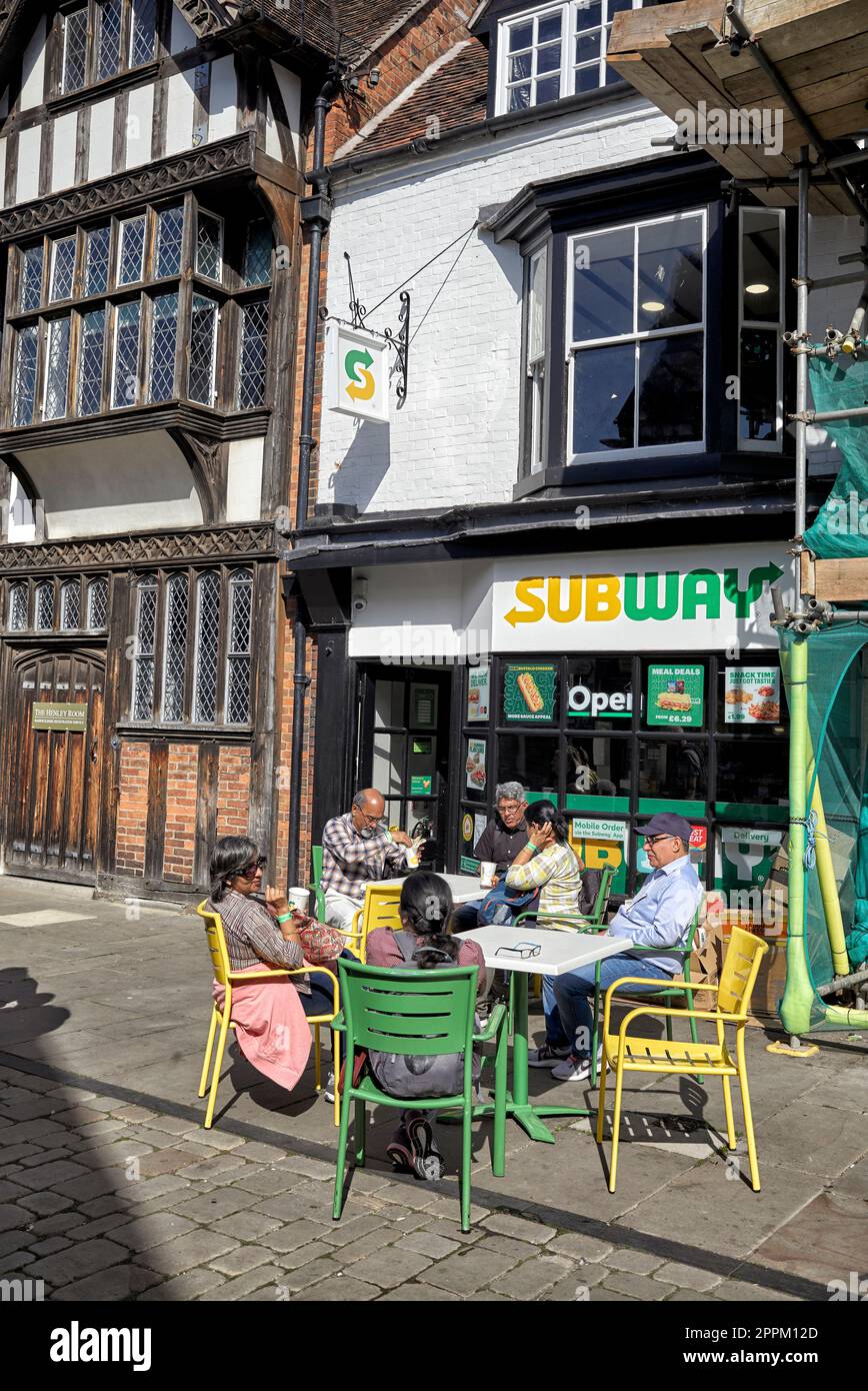 Asian family group dining outside at a Subway restaurant Henley Street