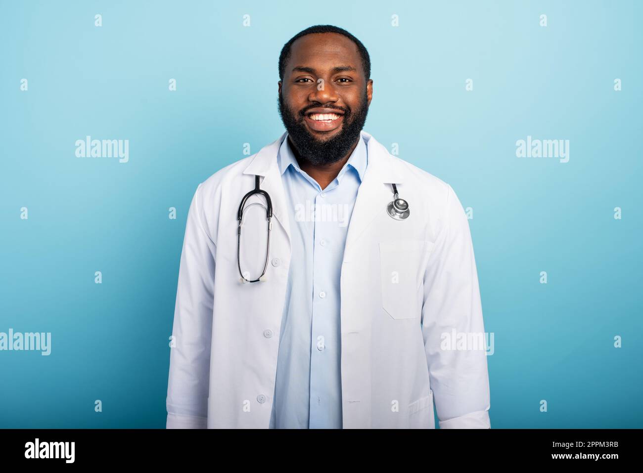 Doctor is happy because the emergency of coronavirus covid-19 are finishing. Light blue background Stock Photo