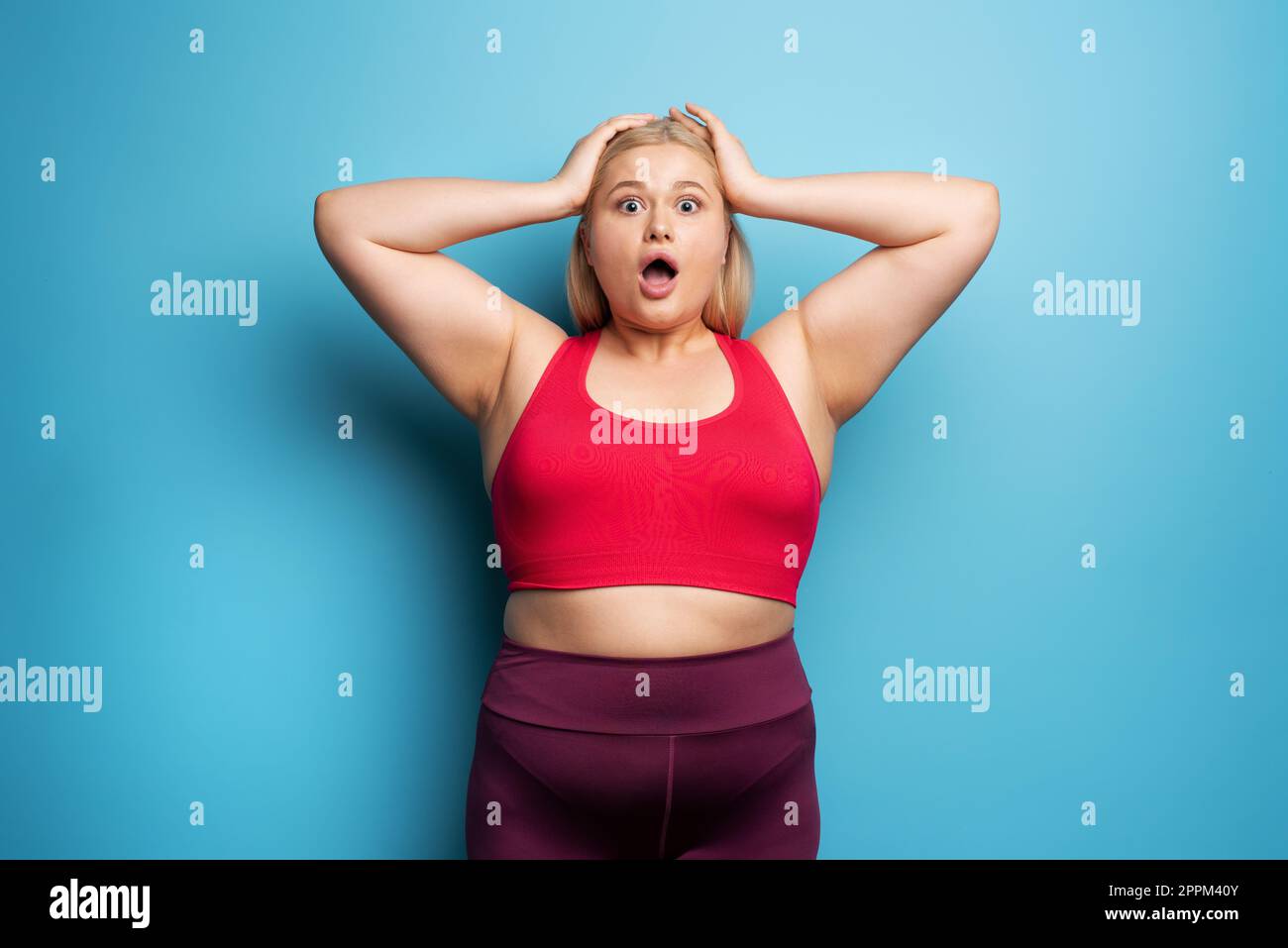 Fat girl is worried because the scale marks a high weight Stock Photo