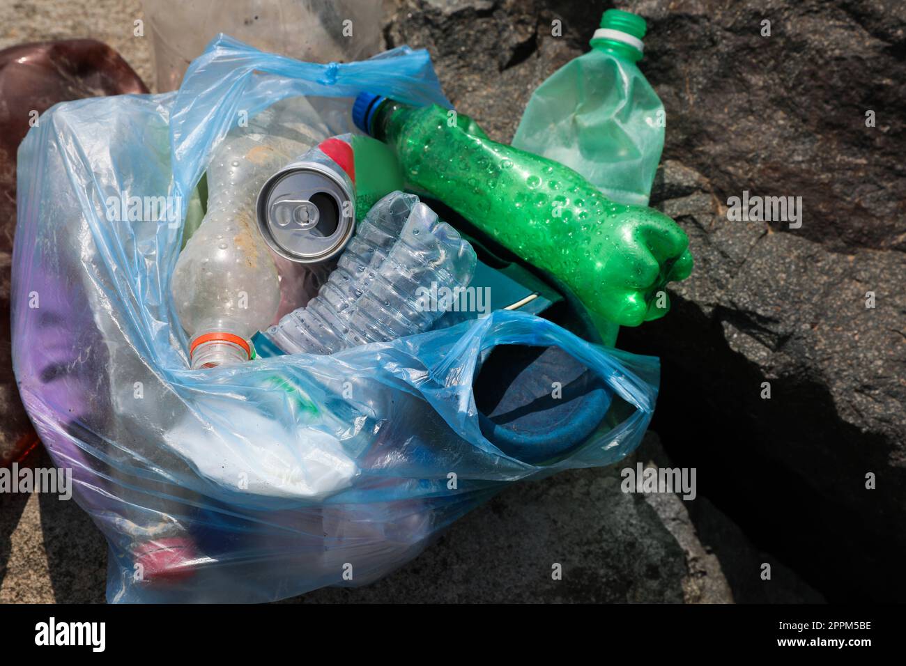 Garbage on stones outdoors, top view. Environmental Pollution concept Stock Photo