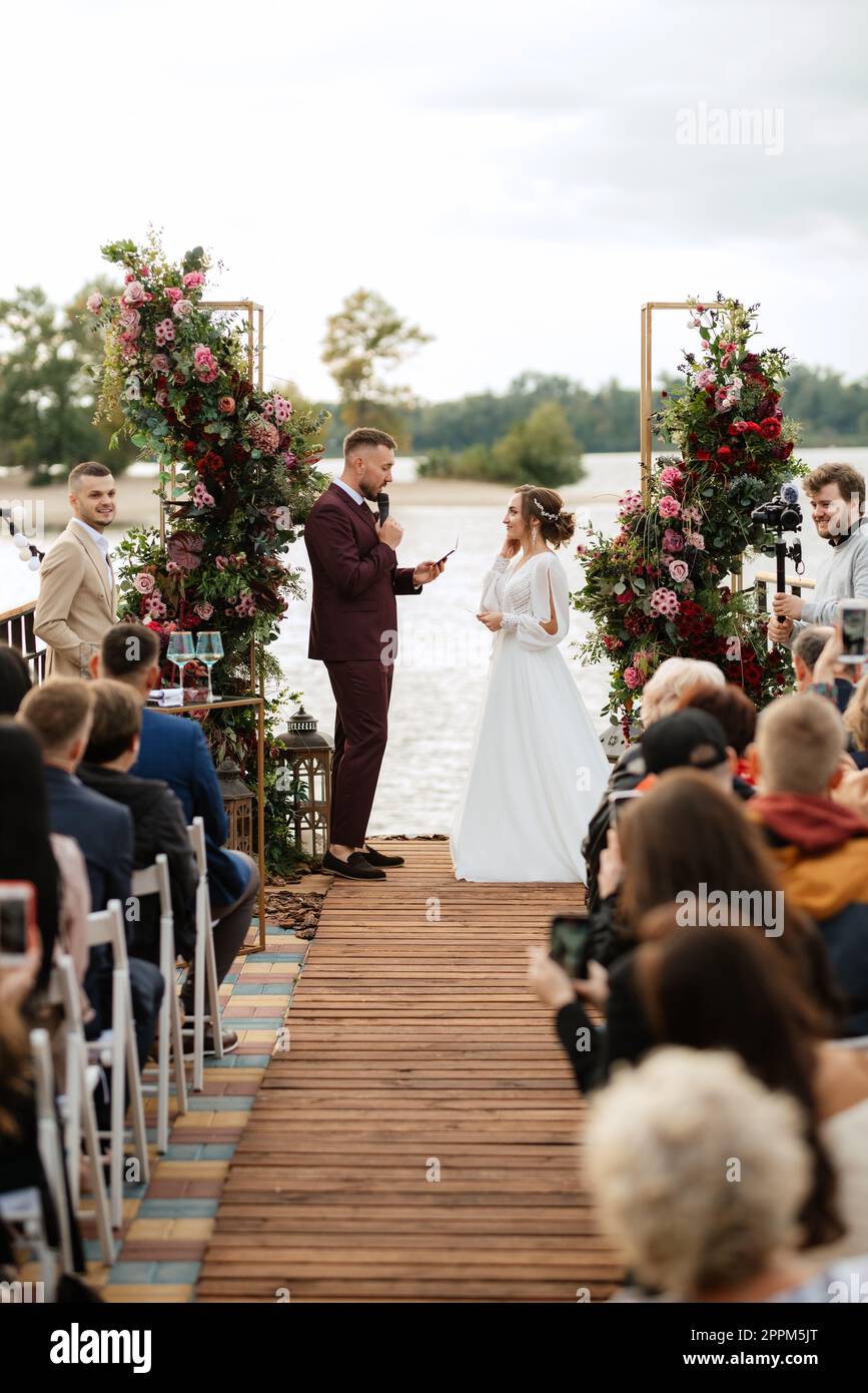 wedding ceremony of the newlyweds on the pier Stock Photo