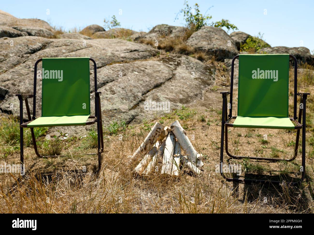 Chairs and dry firewood arranged for bonfire outdoors Stock Photo Alamy