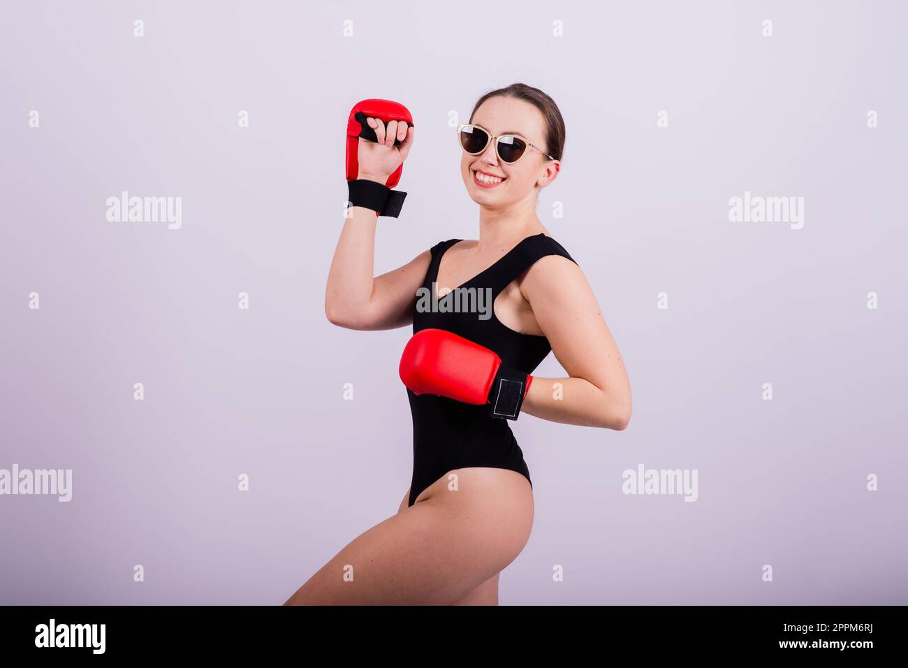 Studio portrait of a boxer female in bodysuit with gloves Stock Photo