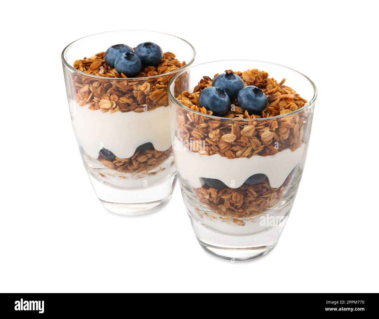 Glasses of tasty yogurt with muesli and blueberries isolated on white Stock Photo