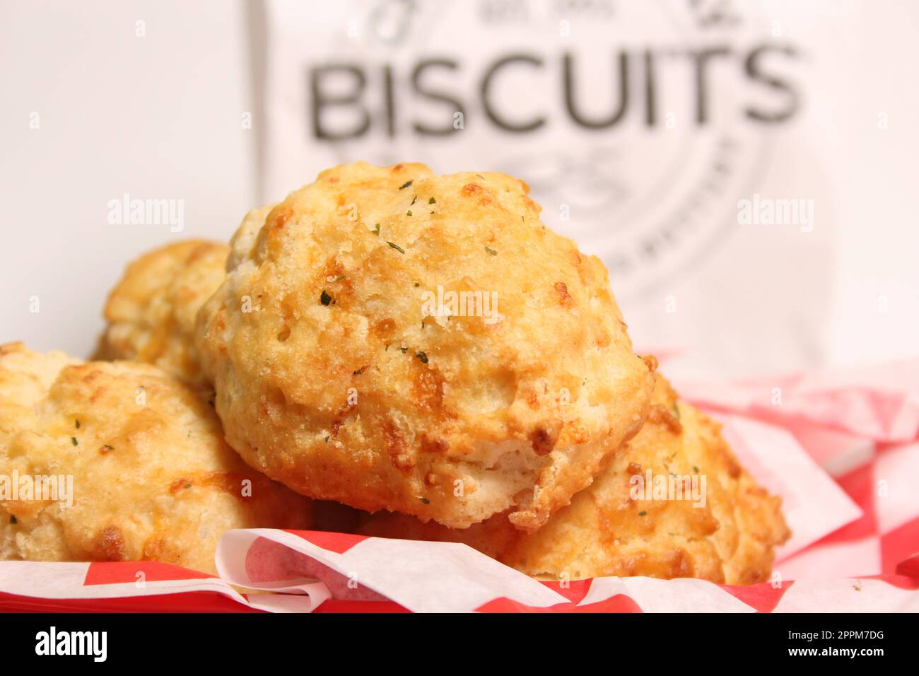 Fresh Garlic Cheese Biscuits With Biscuit Sign in Background Shallow DOF Stock Photo