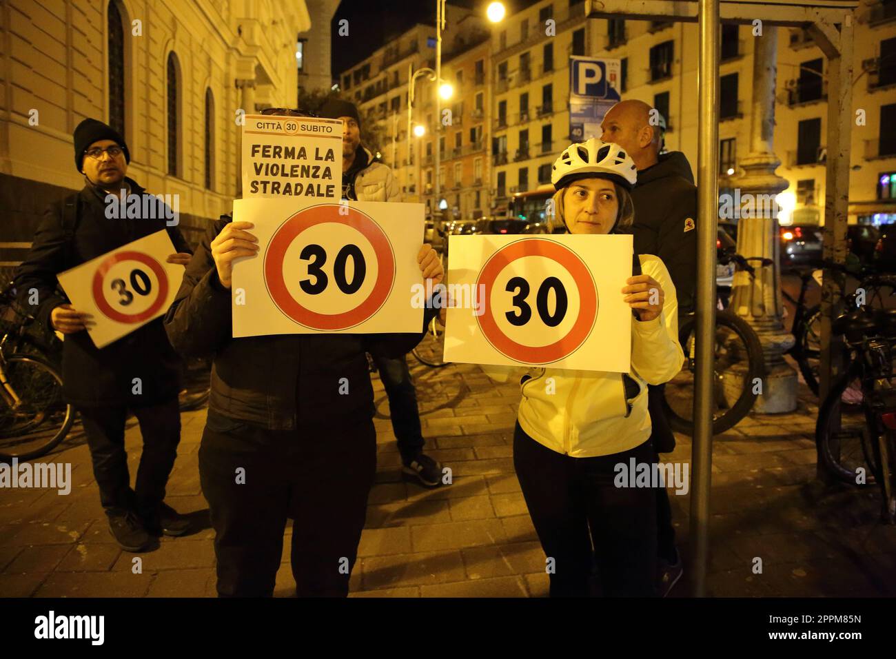 Woman cyclist shows sign prohibition to overcome speed 30 km/h Stock Photo