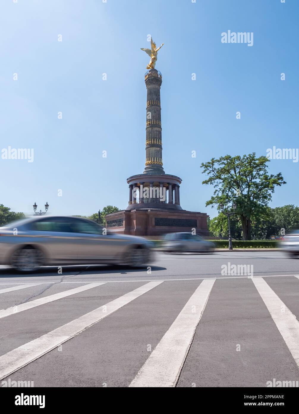 Victory column, Berlin, Germany during summer with clear sky, traffic in front, no people, long exposure, view from low angle Stock Photo