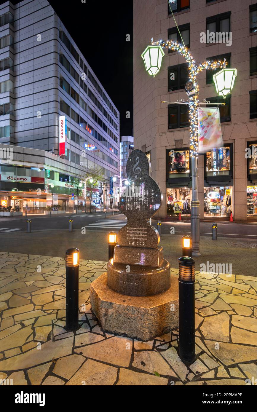 ikebukuro, japan - december 31 2019: Public monument shaped in treble clef with the lyrics of love song 'To Toshima Future' dedicated to Toshima citizens by Sada Masashi on Sunshine Street at night. Stock Photo