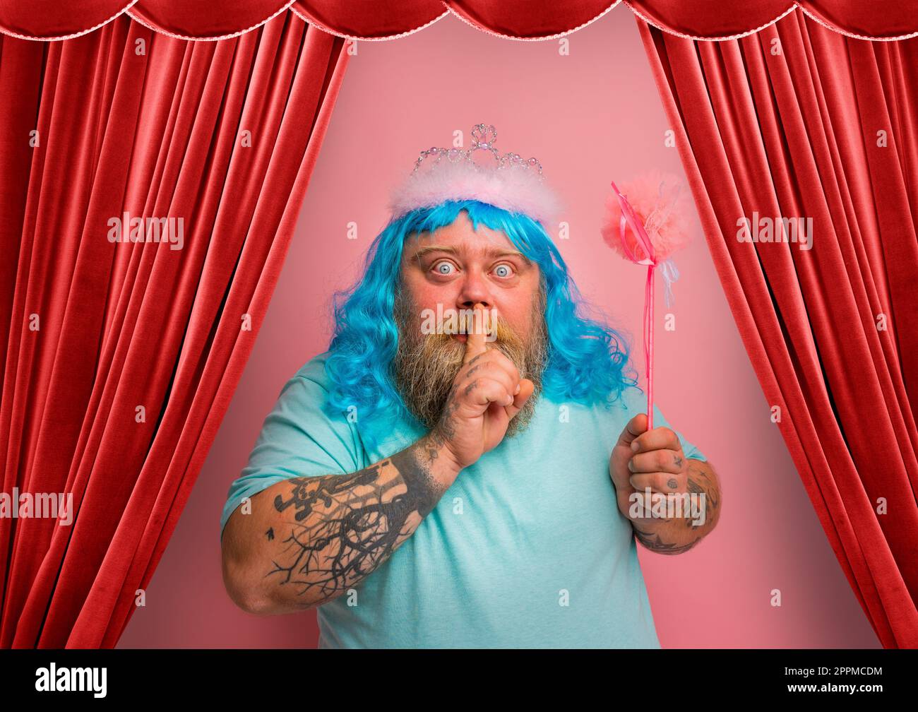 Fat serious man with tattoos acts like a magical fairy Stock Photo