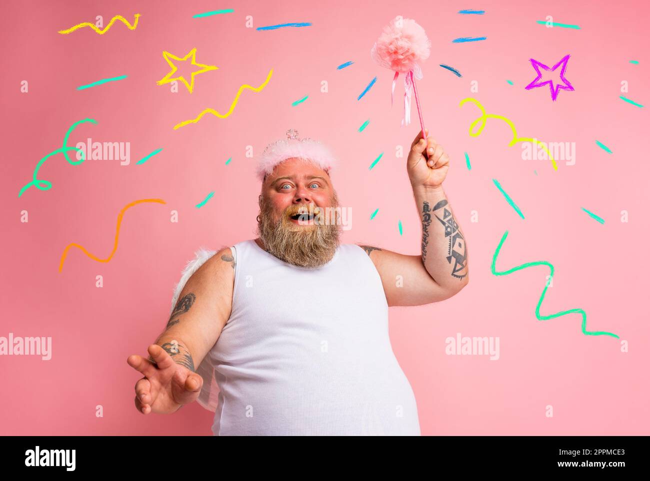 Fat man with tattoos and beard acts like a magic fairy Stock Photo