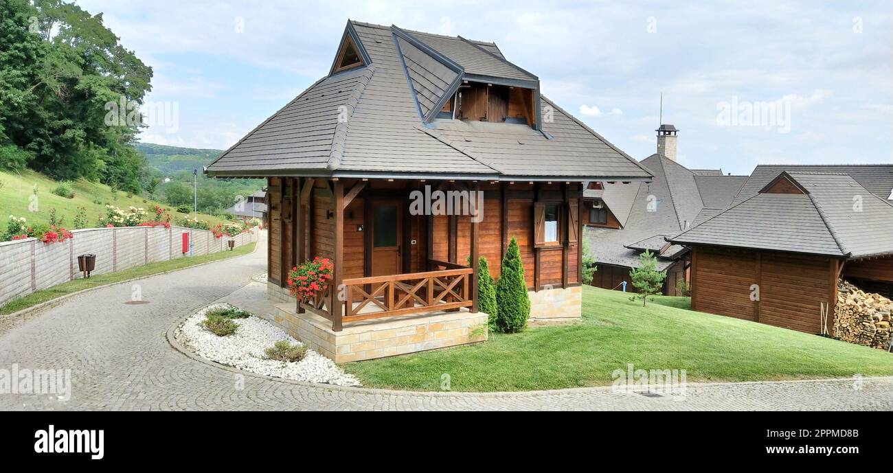July 03, 2020. Vrdnik, Serbia. Bungalows and guest houses in ethnic Levereno style for vacationers. Log Balkan mountain architecture. Hotel or hotel, well-kept lawns Stock Photo