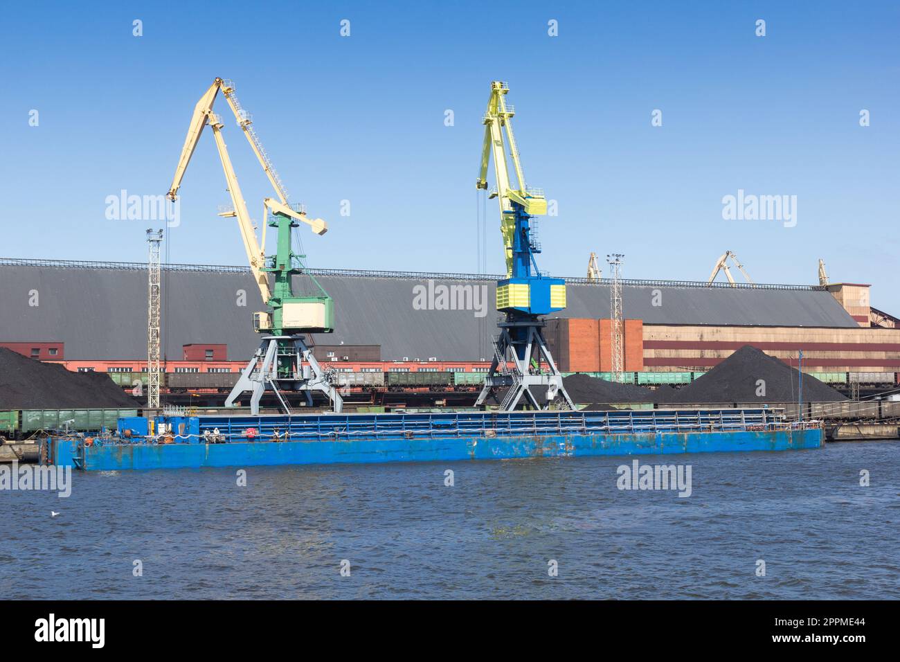 barge is loaded with coal at the port Stock Photo