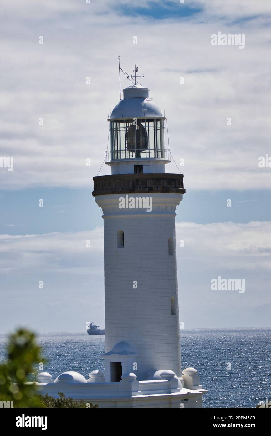 A vertical photograph of the Norah Head lighthouse, with its iconic ...