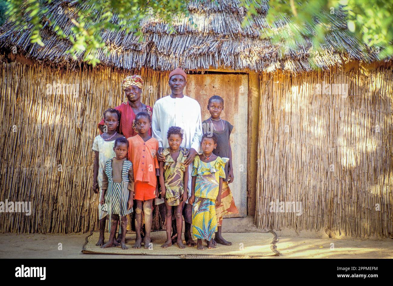 Senegal Family posing in front of their straw house Stock Photo Alamy