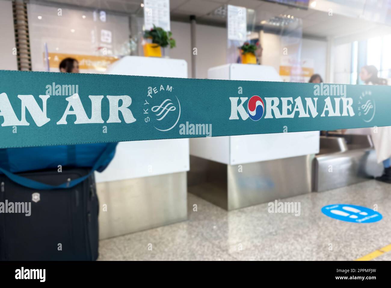 Cyan barrier tape with the Korean Air logo inside an airport. Stock Photo