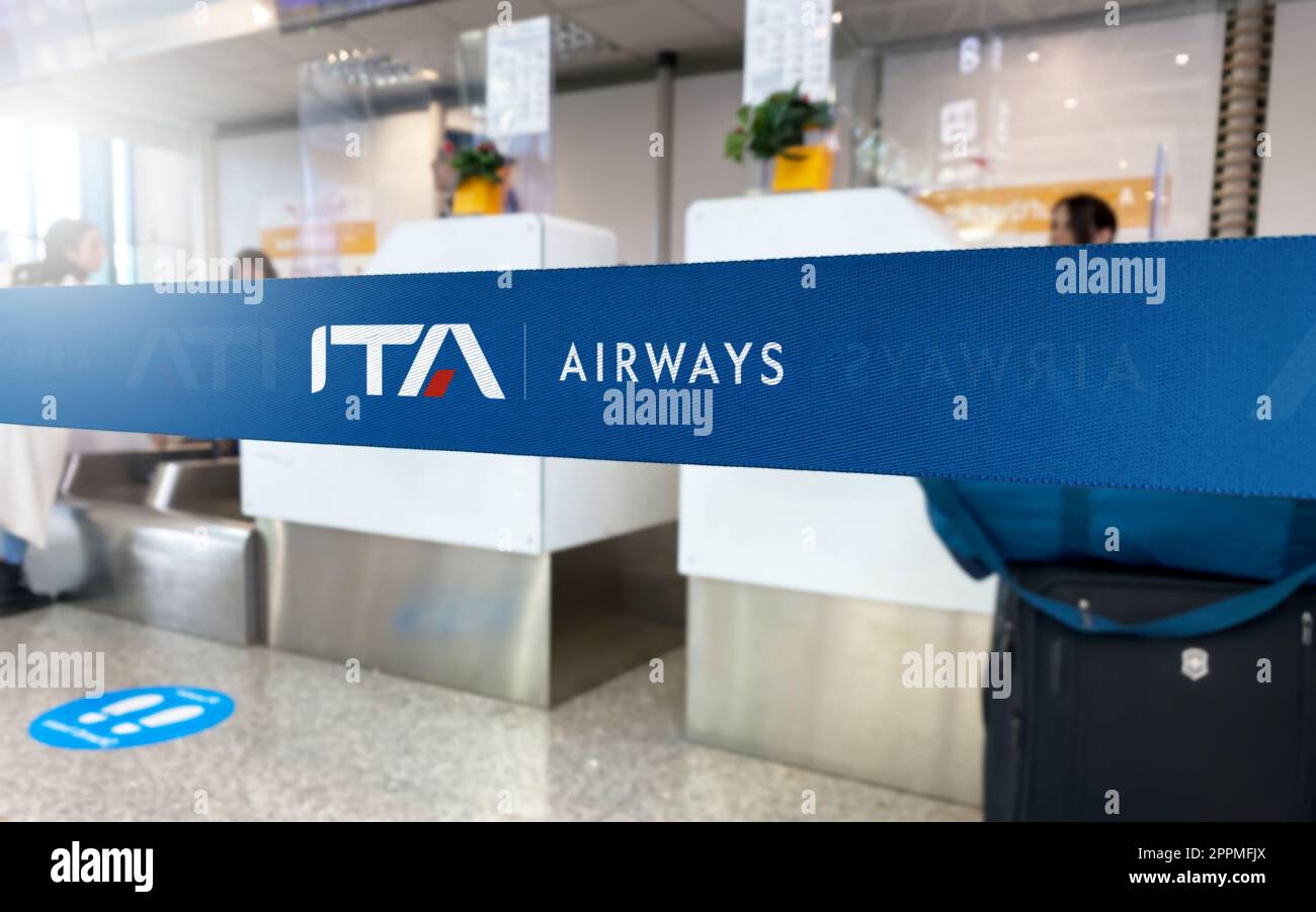 Blue barrier tape with the ITA Airways logo inside an airport Stock Photo