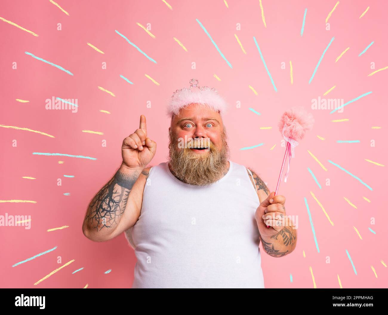 Fat man with tattoos and beard acts like a magic fairy Stock Photo