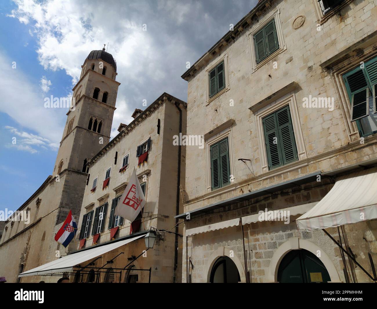 Stradun, Stradone is the main street of the historic city center of Dubrovnik in Croatia. architectural sights. A popular place for tourist walks. August 14, 2022 Tower and facades of ancient houses. Stock Photo