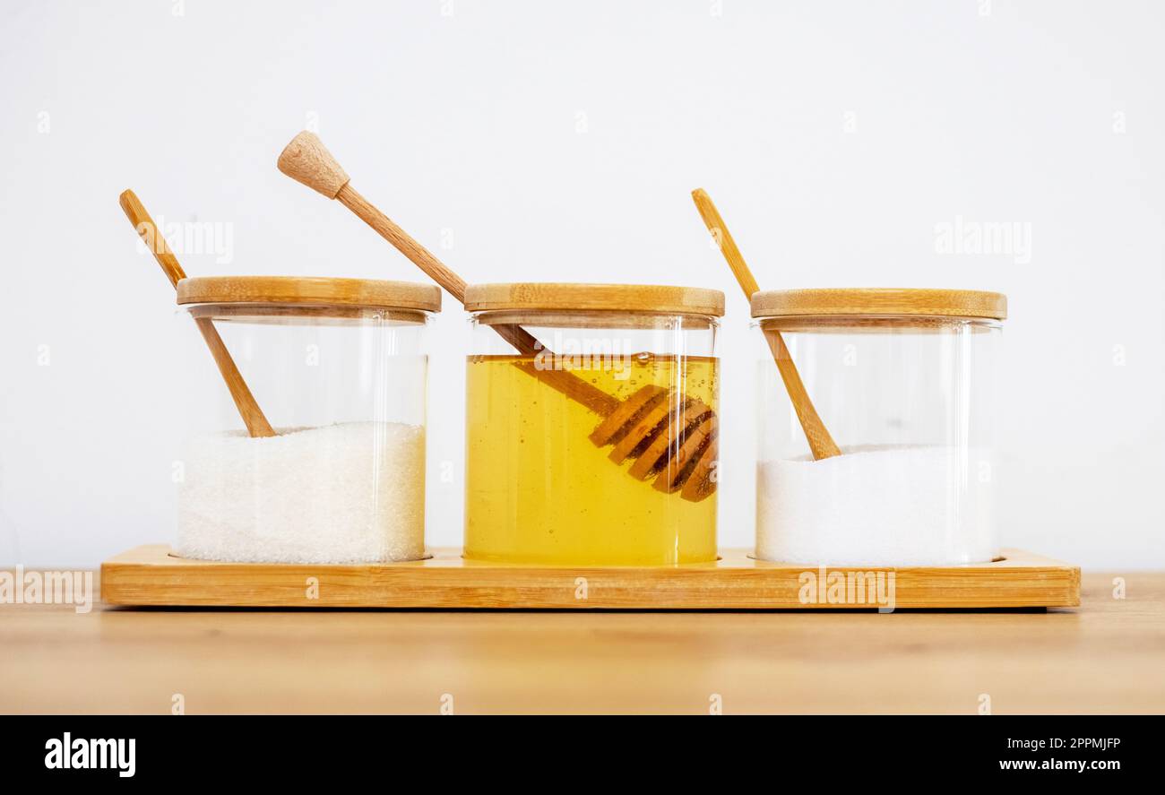 glass jars with salt sugar and honey in. modern kitchen interior Stock Photo